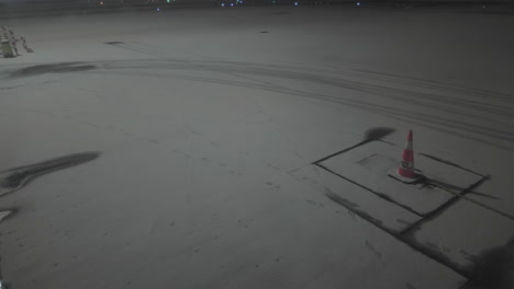 Airport-ramp-covered-in-snow,-camera-tilting-up