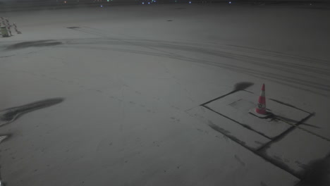 airport ramp covered in snow, camera tilting up