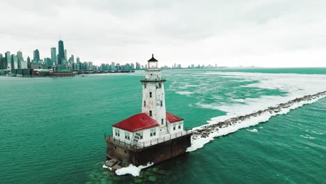 chicago harbor lighthouse in winter with chicago skylines on background