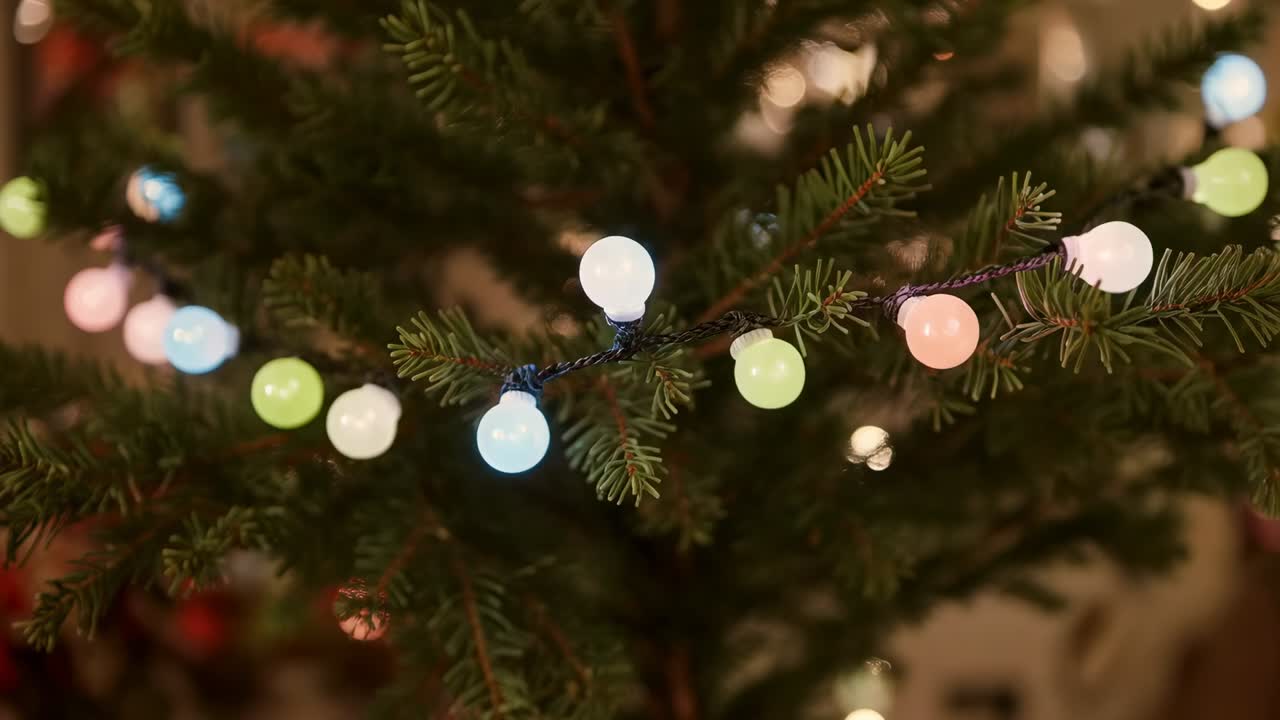 Shining pastel globes changing colors via lighting cycle on pine branch at home for holiday decor
