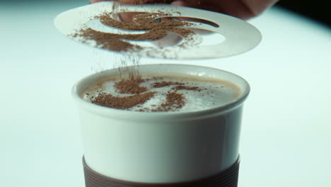 making coffee art with cocoa powder