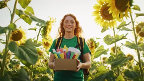 a joyful person explores a sunflower field while holding a box filled with colorful art supplies.