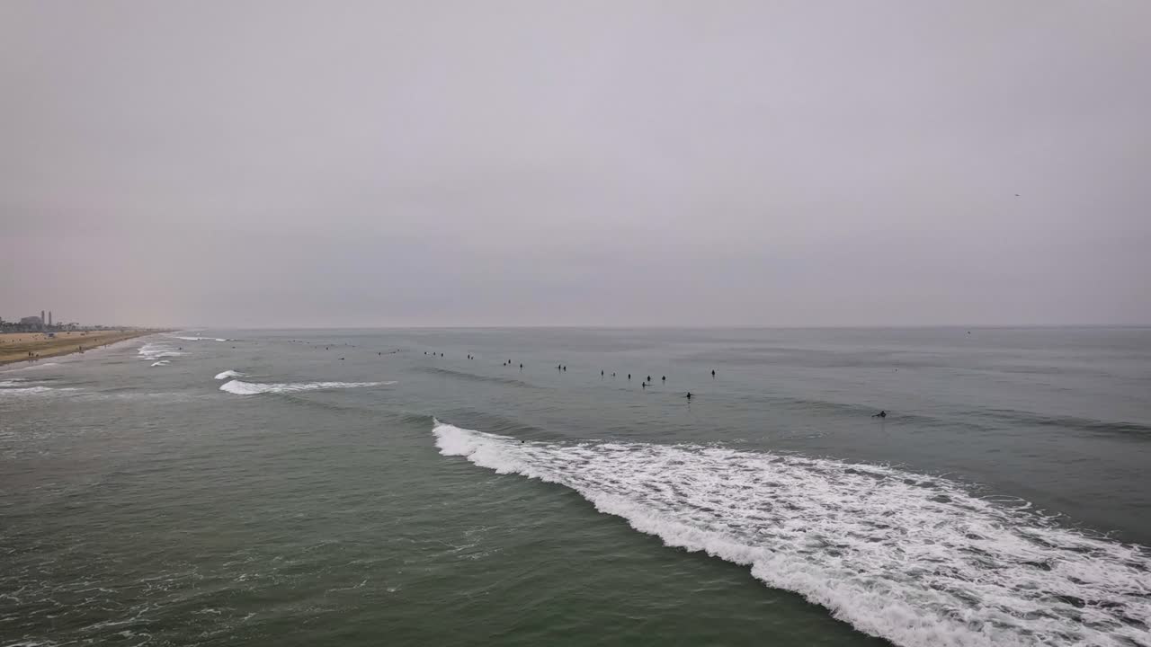 Surfers in the Ocean on a Cloudy Day