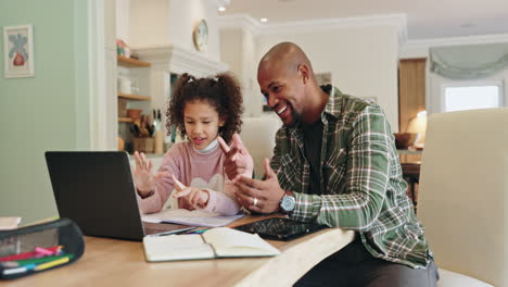 father and daughter learning together at home using a laptop