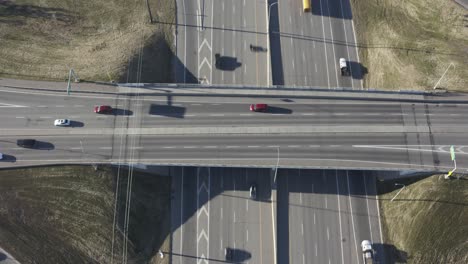 aerial hold overpass freeway on a hot summer morning commuter rush hour quiet less traffic than normal because of covid-19 pandemic restrictions with light traffic of commercial vehicles in highway