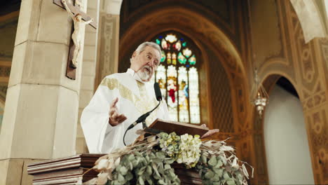 holy man, priest and preaching in church on podium