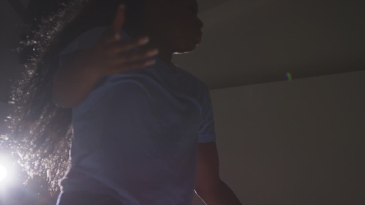 Backlit Studio Shot Of Young Woman Dancer Dancing Against Grey Background