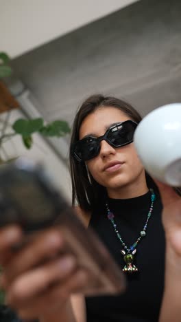 woman looking at smartphone, wearing sunglasses