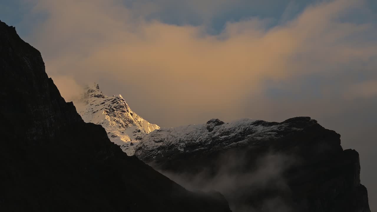 Dark Sunset Mountain Scenery in Nepal, Himalayas Mountains with Dramatic Orange Sunset Clouds in the Annapurna, a Popular Hiking and Trekking Route in Nepal
