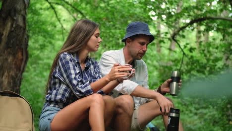 couple enjoying a drink in the forest