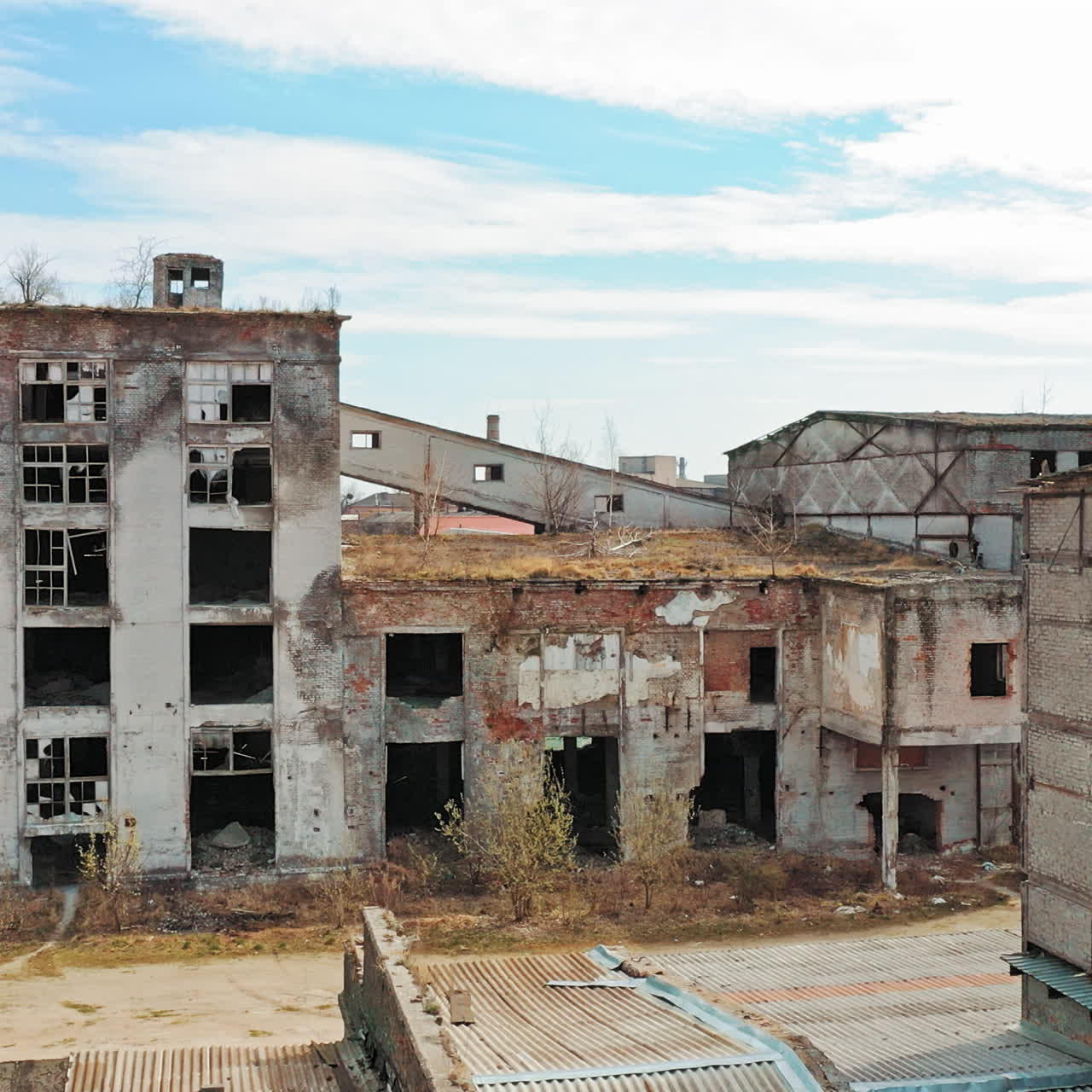 Aerial view of an old factory ruin and broken windows. Old industrial building for demolition.