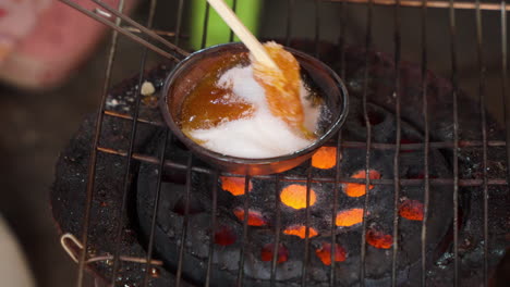 old style dalgona sugar candy cooking process in south korea - close-up