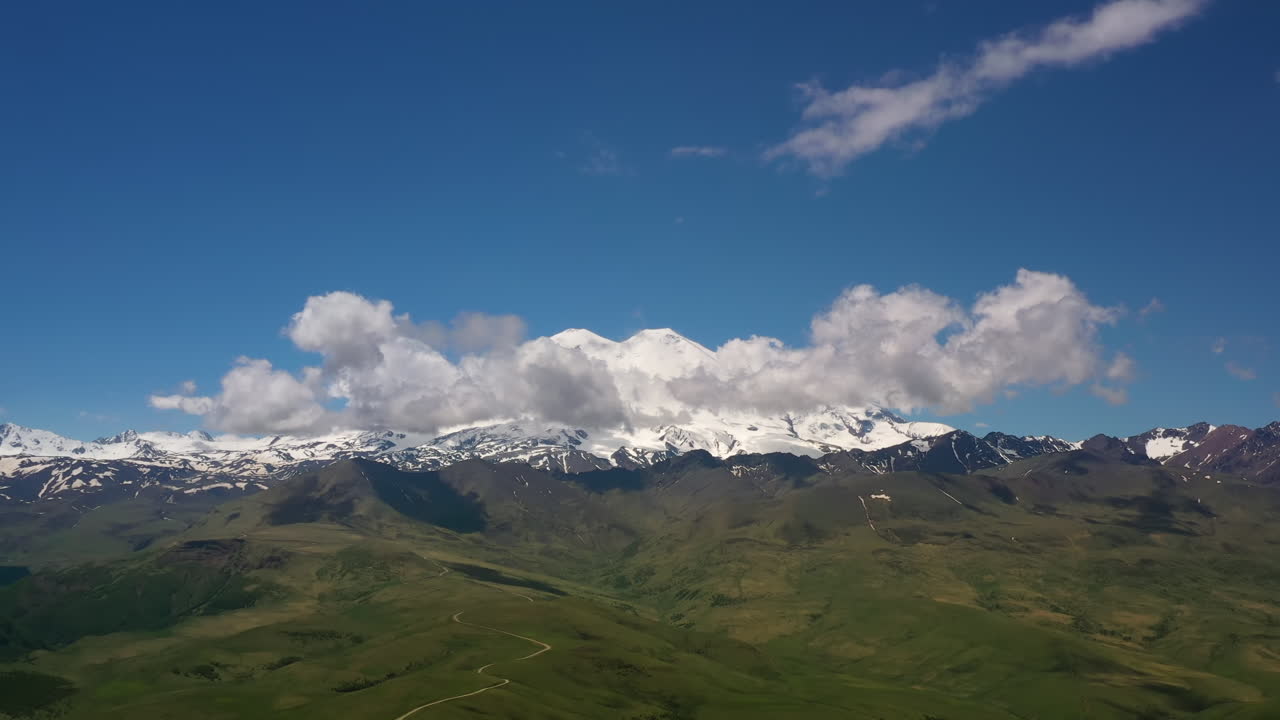 Elbrus Region. Flying over a highland plateau. Beautiful landscape of nature. Mount Elbrus is visible in the background.