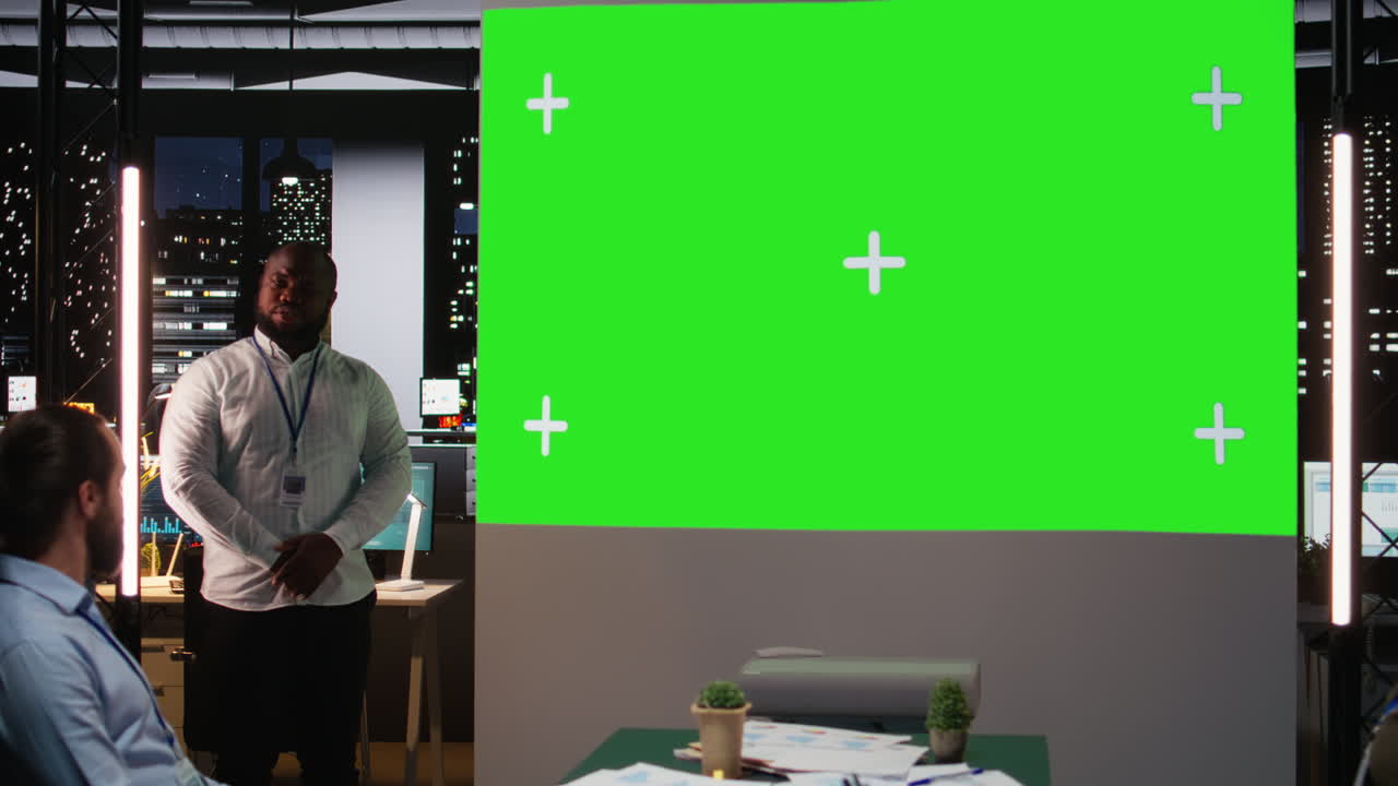 Black male supervisor hosting a late meeting with chroma key display