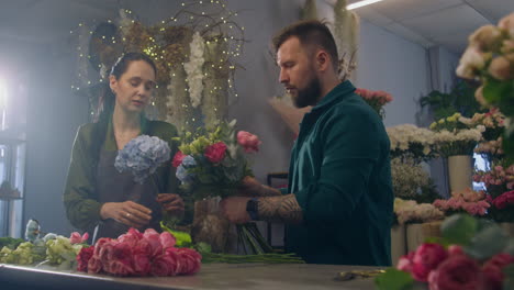 two florists together create beautiful bouquet