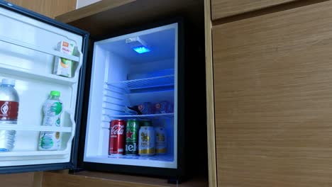 hand reaching into fridge for a cold drink.