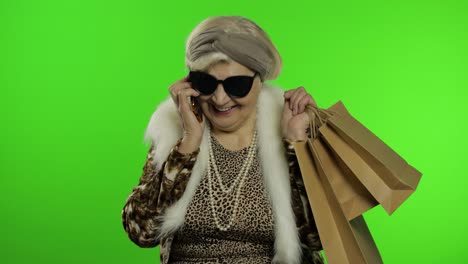 elderly caucasian grandmother woman using smartphone. make shopping. chroma key