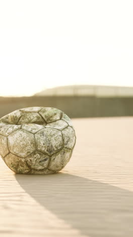 old soccer ball on a beach