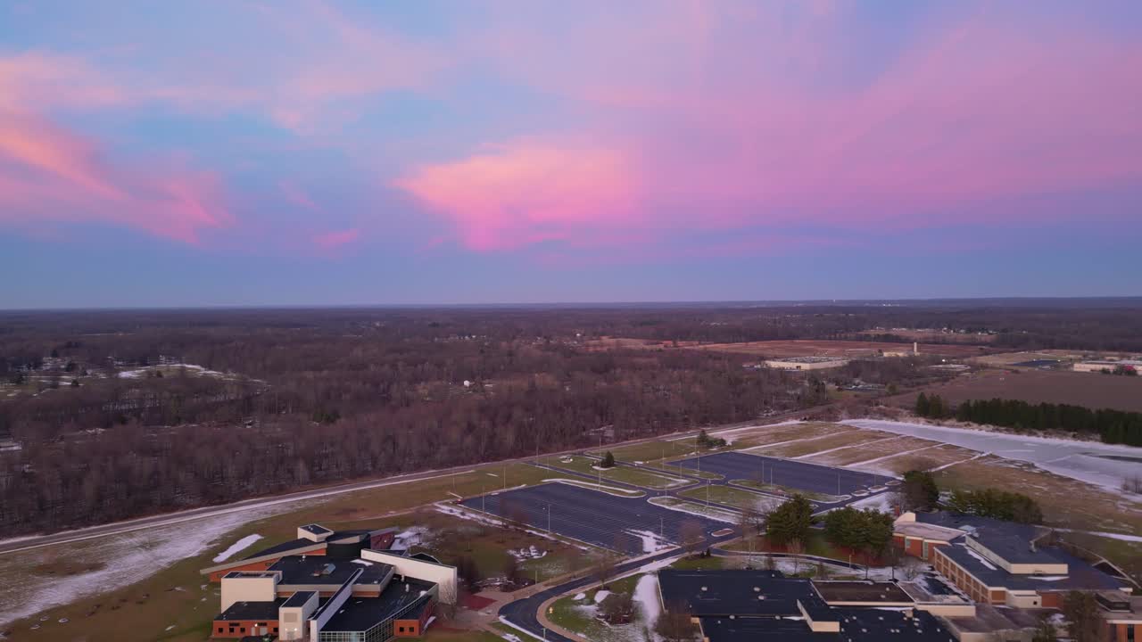 Drone shot capturing a vivid sunset over a snow-dusted landscape. Perfect for projects highlighting nature's beauty or atmospheric scenes.
