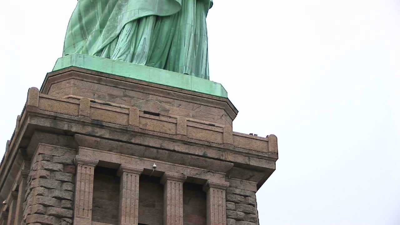 la cámara se desplaza desde la base del museo hasta la estatua de la libertad hasta la antorcha