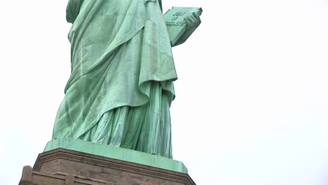 the camera pans from the museum base up the statue of liberty to the torch