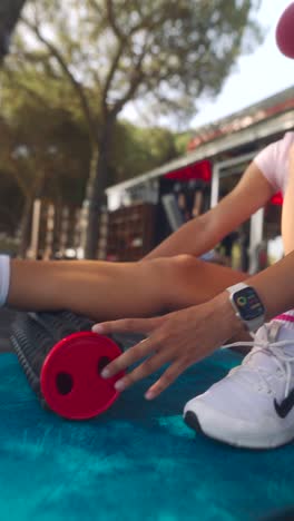 woman using a foam roller for leg muscle recovery