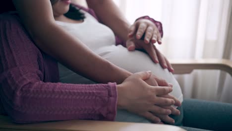 pregnant couple feels love and relax at home.