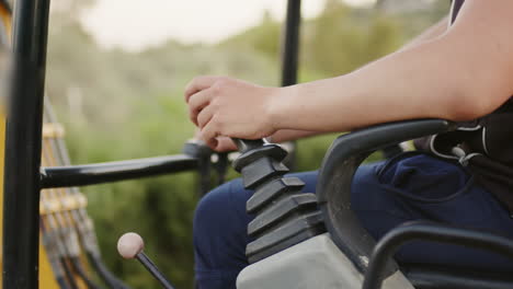 hand of worker moving excavator knobs