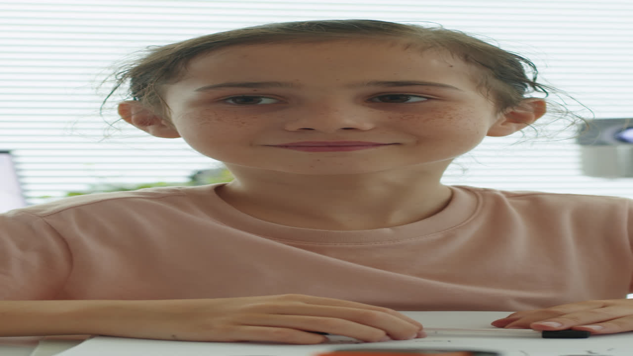 Intelligent Elementary School Girl at Class Desk