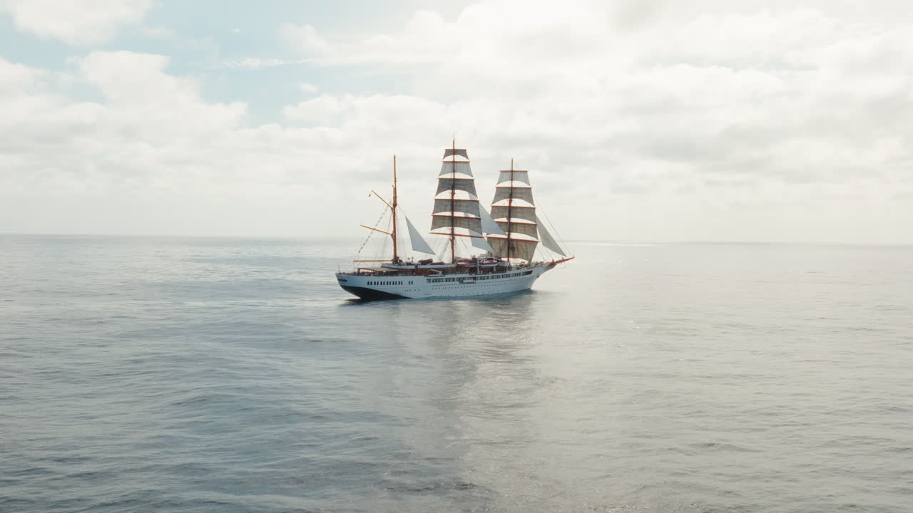 Aerial pan shot of a retro ship sailing on Atlantischer Ocean during daytime.