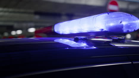 red and blue lights glowing on police car. siren lighting on roof of vehicle