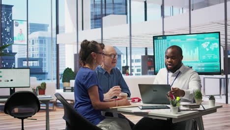 insurance adviser explaining retirement plans to mature people in a modern office