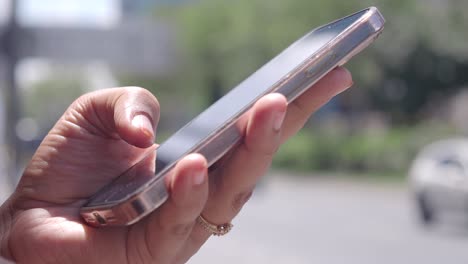 a person uses a smartphone in their hand