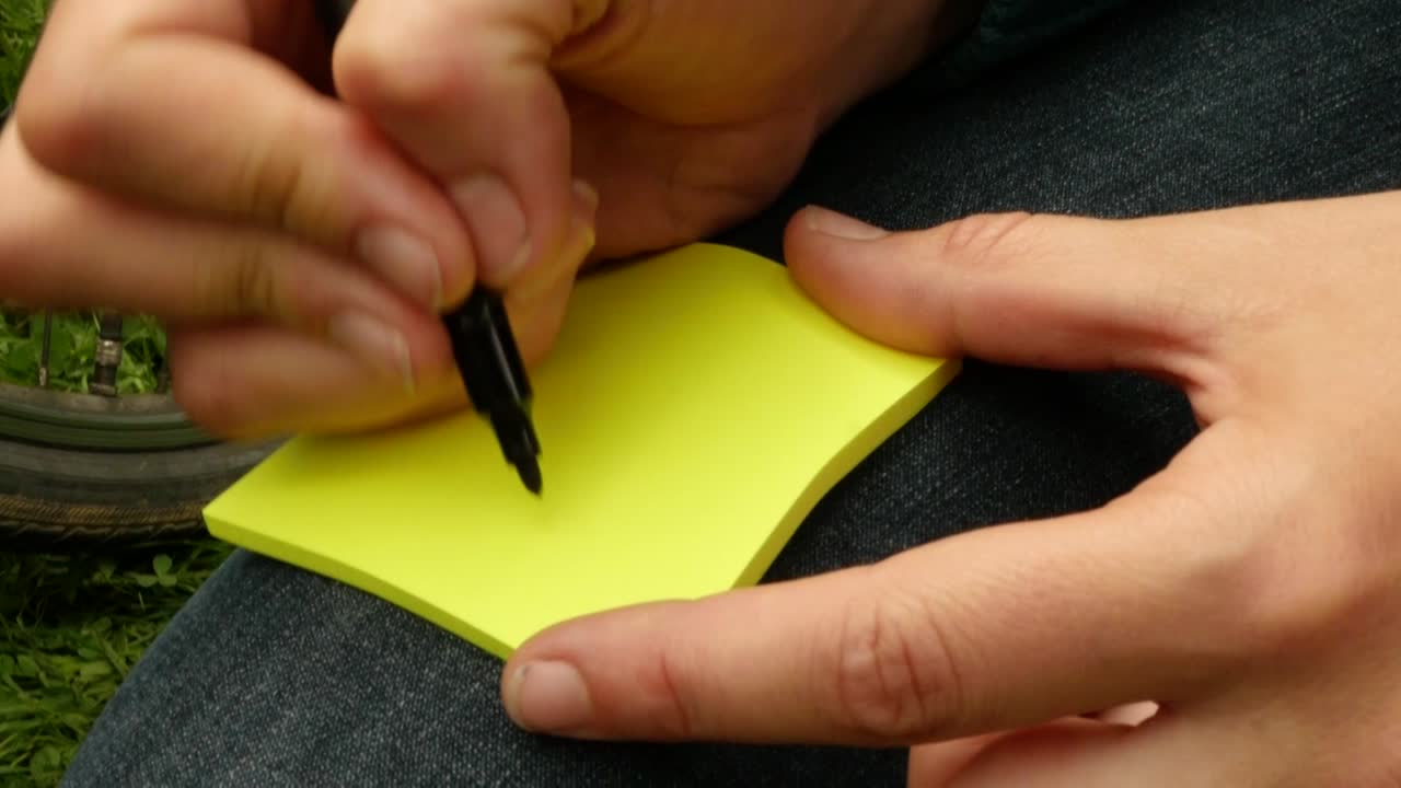 woman is writing "sich begeistern lassen" (get enthused) an a post-it