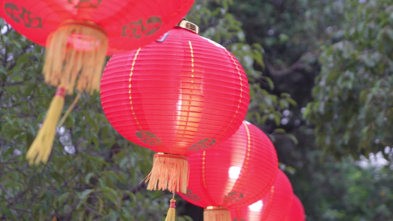 Red Chinese Lanterns Hanging Outdoors in a Row