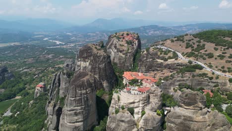 meteora monasteries in greece mainland - popular tourist attraction and unesco world heritage site - aerial 4k