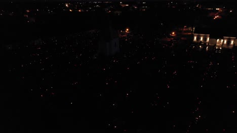 Aerial-Over-Graveyard-At-Night-With-Candlelights-In-The-Dark