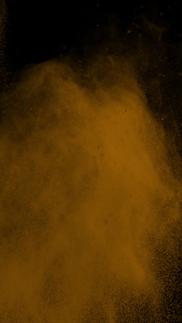 Super Slow Motion Shot of Orange Color Powder Explosion at 1000Fps Vertical View