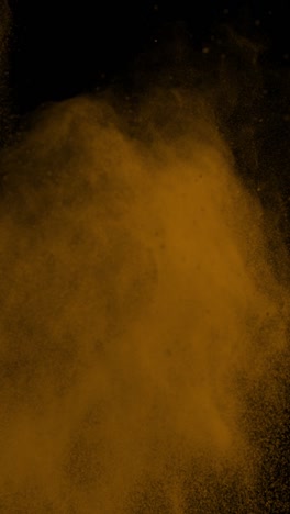 super slow motion shot of orange color powder explosion at 1000fps vertical view