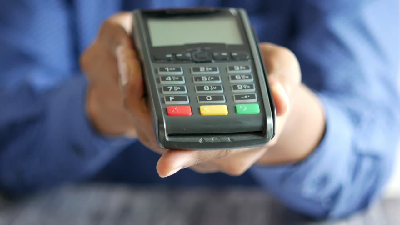 Person holding a payment terminal