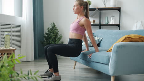 woman doing home workout on a couch