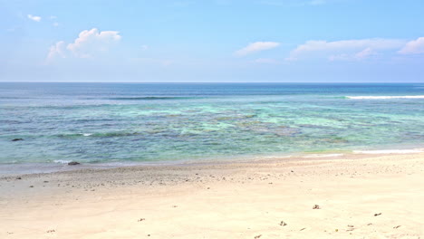 Empty-white-sand-beach-line-and-turquoise-transparent-sea-water-tides-on-a-cloudy-day-in-Thailand,-Generic,-static