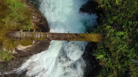 Suspension-bridge-over-the-mountain-river,-Norway.