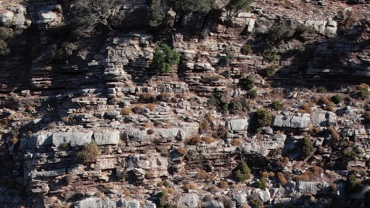 Stunning aerial view of rocky cliffs and sparse vegetation in Greece