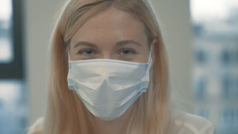 portrait of happy girl looking at camera with face mask indoor