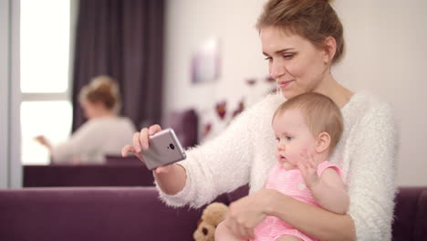 selfie mom and daughter at home. beautiful woman with child taking phone photo