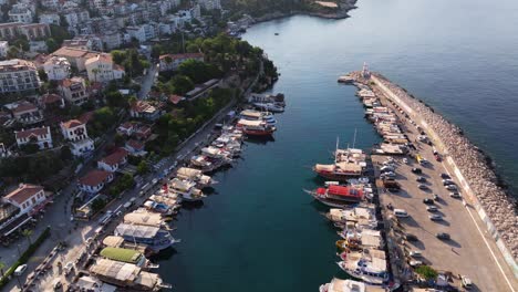 aerial high angle above kas, antalya, with boats anchored along the coast, lush green hills, and the blue mediterranean waters