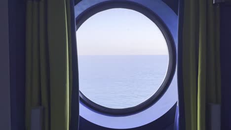 a quiet view through a ship’s window — the open sea, soft movement, and calm waters. a moment of stillness during a journey across the ocean