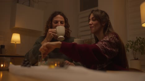 couple enjoying hot drinks at home