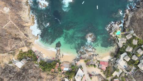 Jib down and zenith view of small beach with tourists swimming